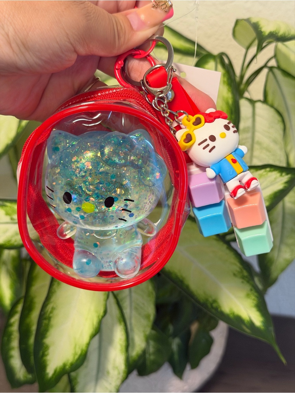 Hello Kitty Red Pouch Keychain with Blue Glitter Squishy and Pastel Charm Stack